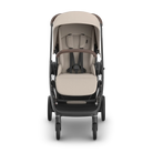 A stroller with a beige and brown color scheme, shown from a front-facing perspective on a clean white background.