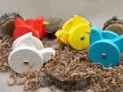 Colorful wooden bird toys with wheels on a natural background