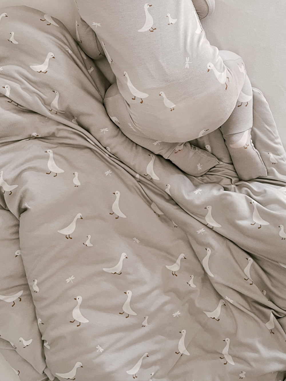 Gray bedding set with duck pattern on a neutral background