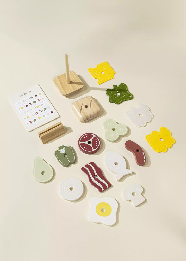 Set of wooden toys shaped like food items on a beige background