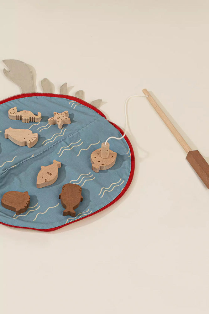 Wooden fishing game with hooks and fish on a blue mat
