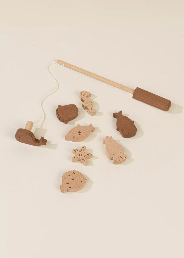 Wooden fishing rod toy with various fish-shaped wooden figures on a beige background