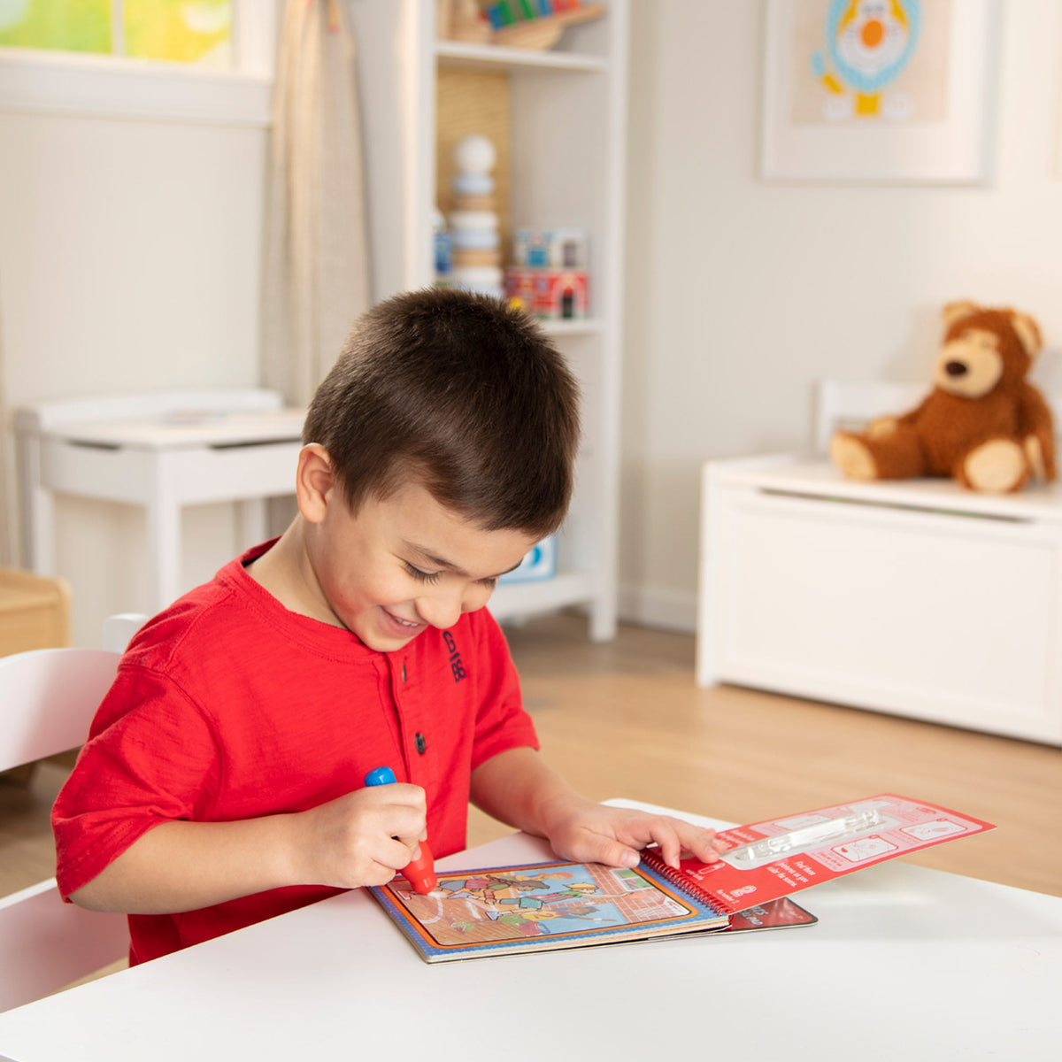 Child playing with toys at a table in a room with stuffed animals