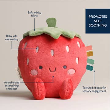 Strawberry-shaped plush toy with text highlighting features on a beige background