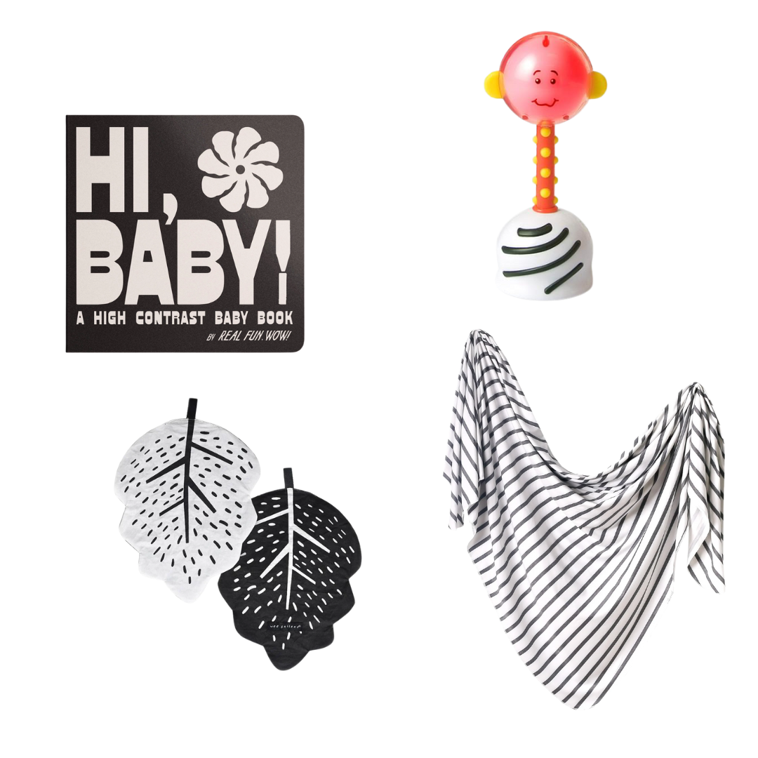 A baby gift set featuring a black book titled 'HI, BABY! A HIGH CONTRAST BABY BOOK' with white lettering, a pink and orange baby rattle, two black and white leaf-shaped items, and a black and white striped triangular scarf, all arranged on a plain white background.