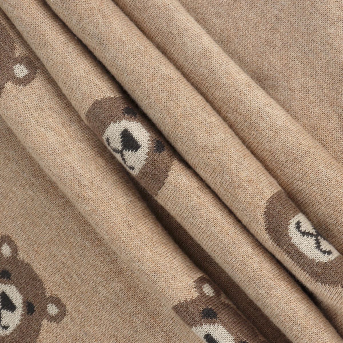 Close-up of beige fabric with teddy bear patterns