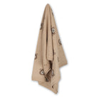 Beige knitted blanket with bear patterns on a white background