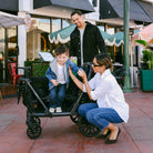 Family with a child in a stroller on a sidewalk