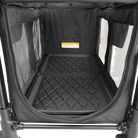 Black pet crate with textured floor and mesh sides on a white background