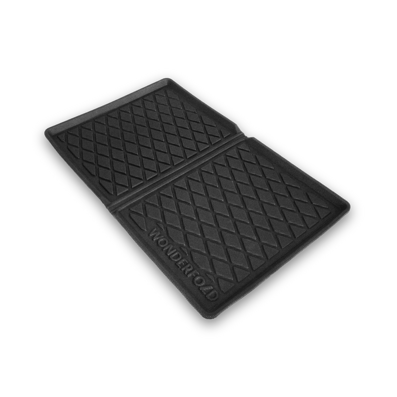 Black rubber mat with textured surface on a white background