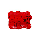 Red gummy bear-shaped mold on a white background