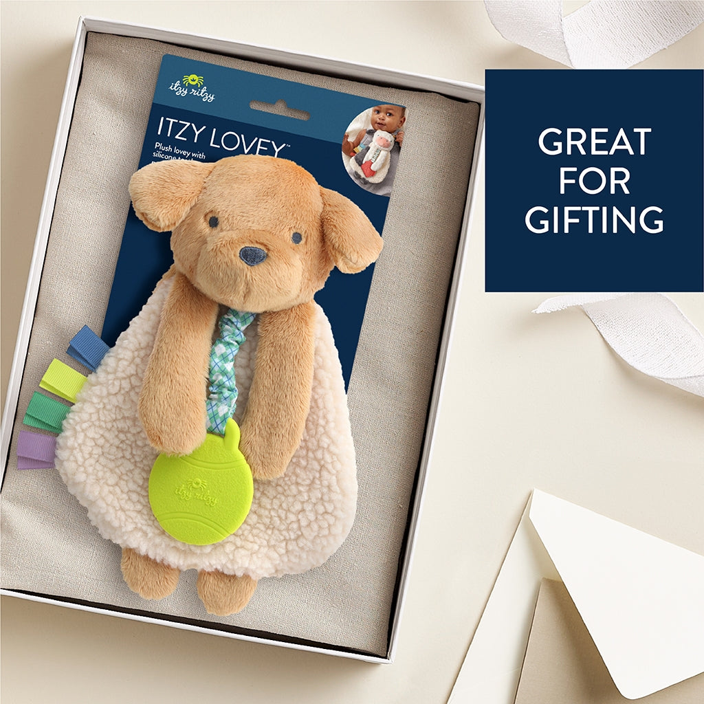Dog-shaped Itzy Lovey toy in packaging with text 'Great for gifting' on a light background