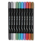 Ten black double-ended tattoo markers from the Tattoo Flair - 10 Tattoo Markers and 12 Stencils by Snifty set lined up side by side against a white background, each featuring the "Tattoo Flair" name printed on the barrel and capped with a different metallic marker color, including silver, white, green, teal, blue, purple, pink, red, bronze, and gold.