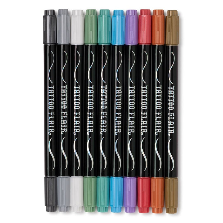 Ten black double-ended tattoo markers from the Tattoo Flair - 10 Tattoo Markers and 12 Stencils by Snifty set lined up side by side against a white background, each featuring the "Tattoo Flair" name printed on the barrel and capped with a different metallic marker color, including silver, white, green, teal, blue, purple, pink, red, bronze, and gold.
