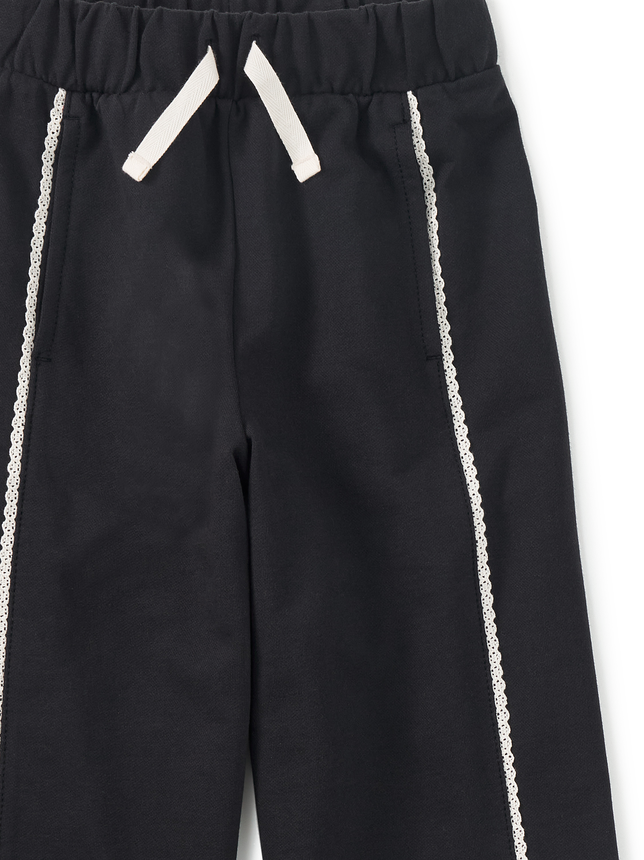 Black pants with white drawstrings and side stripes on a white background