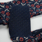Navy blue floral-patterned fabric with a textured surface on a white background