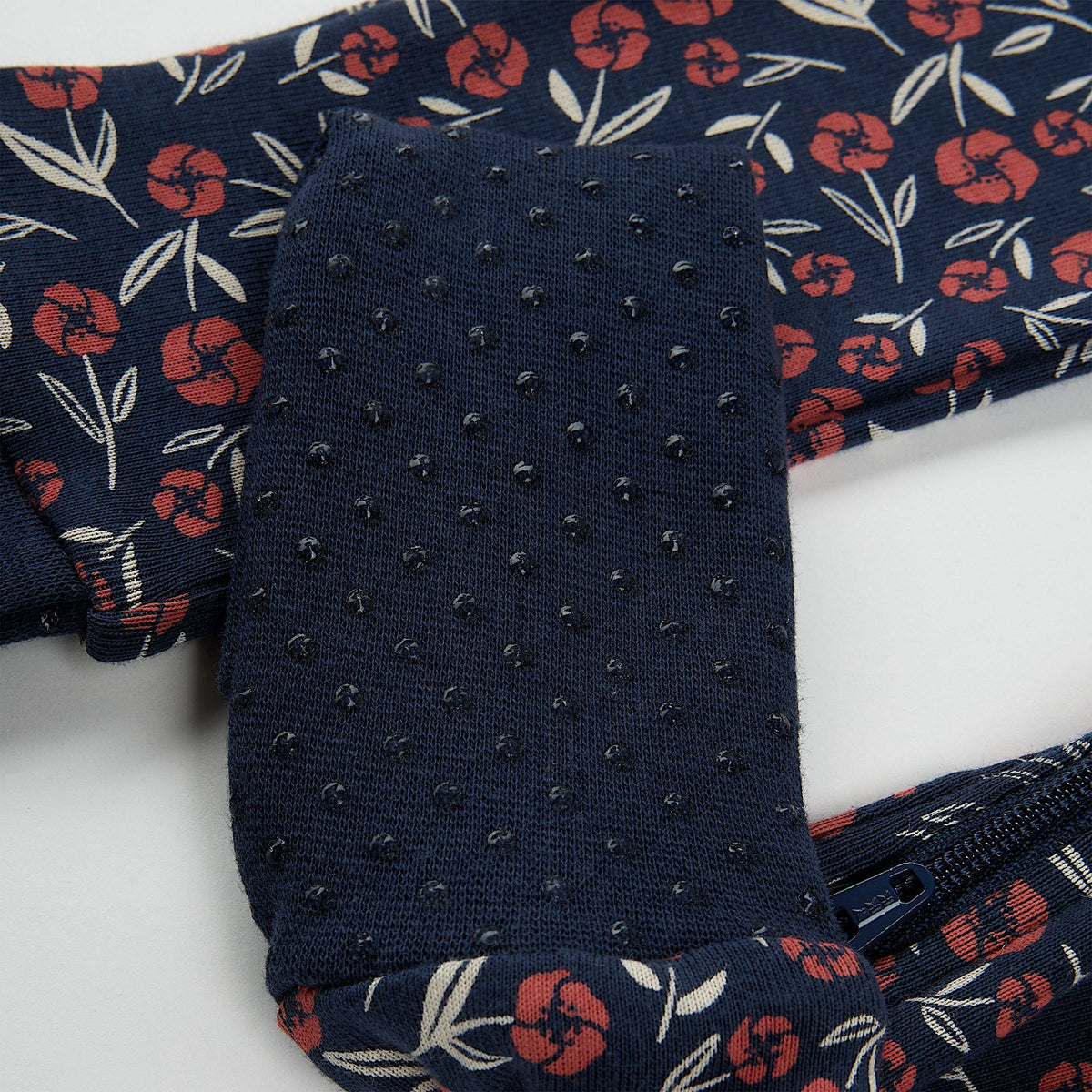 Navy blue floral-patterned fabric with a textured surface on a white background