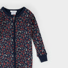 Navy onesie with red floral pattern on a white background