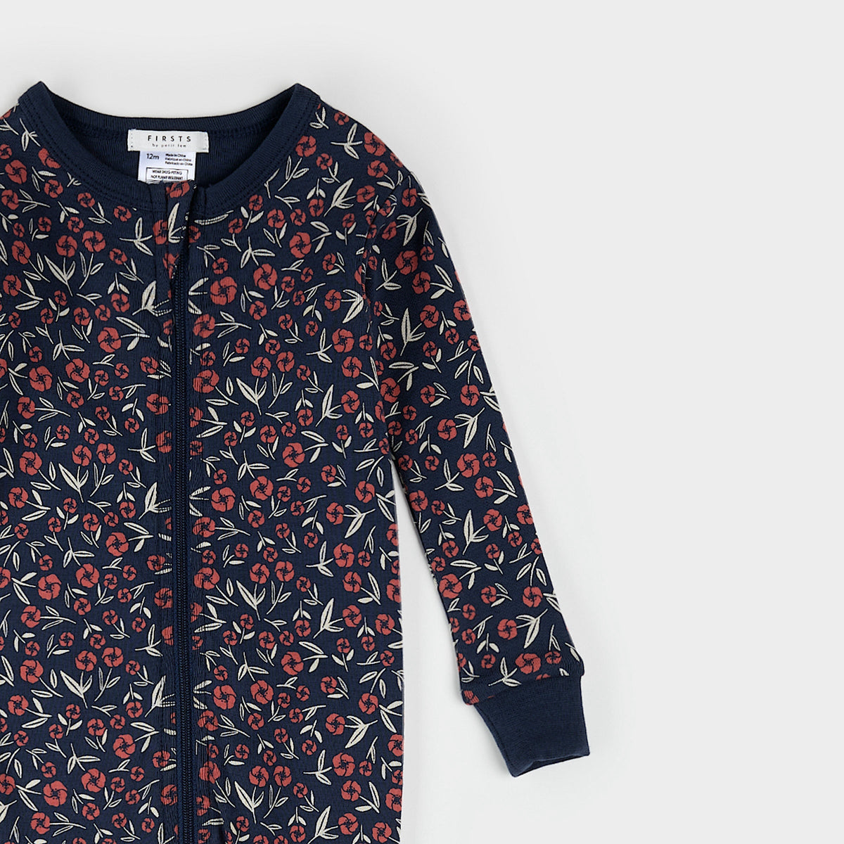 Navy onesie with red floral pattern on a white background