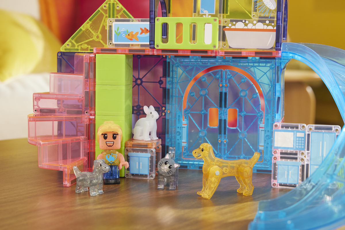 Toy set with transparent blocks, figures, and animals on a wooden surface