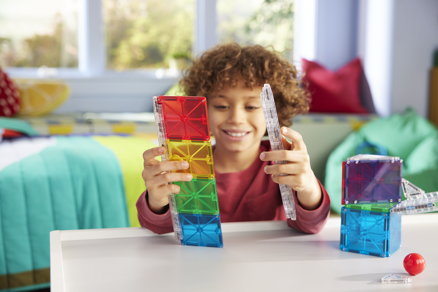Child playing with colorful building blocks in a bright room