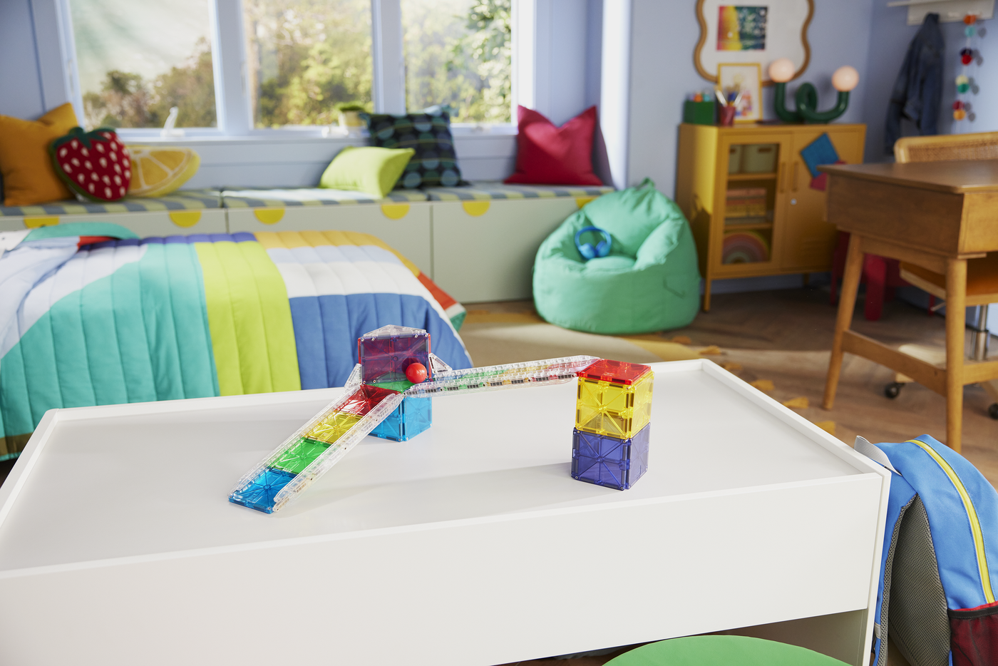 Children's room with a play table, colorful blocks, and a bean bag chair.