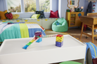 Children's room with a play table, colorful blocks, and a bean bag chair.