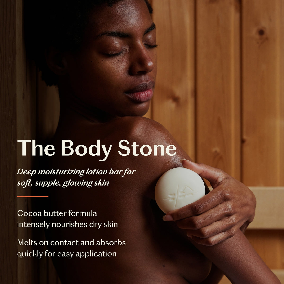 Person holding a white lotion bar with text about 'The Body Stone' product.
