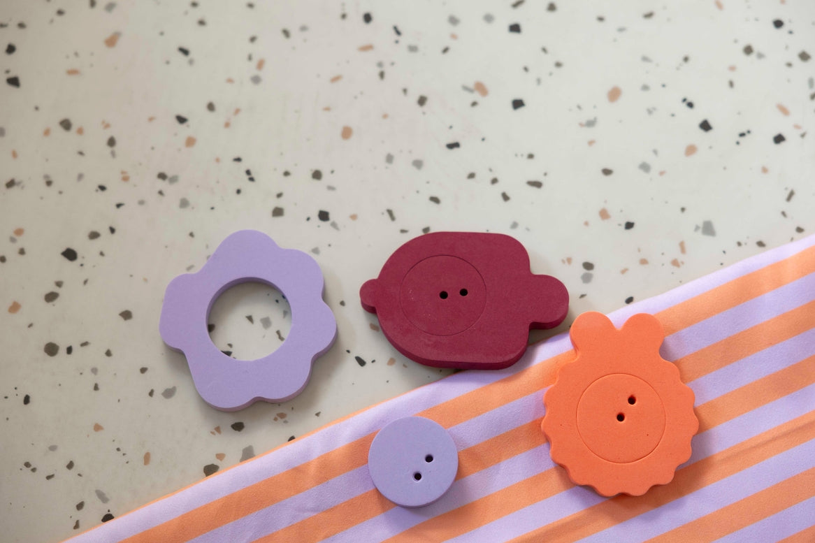 Colorful buttons on a striped fabric background