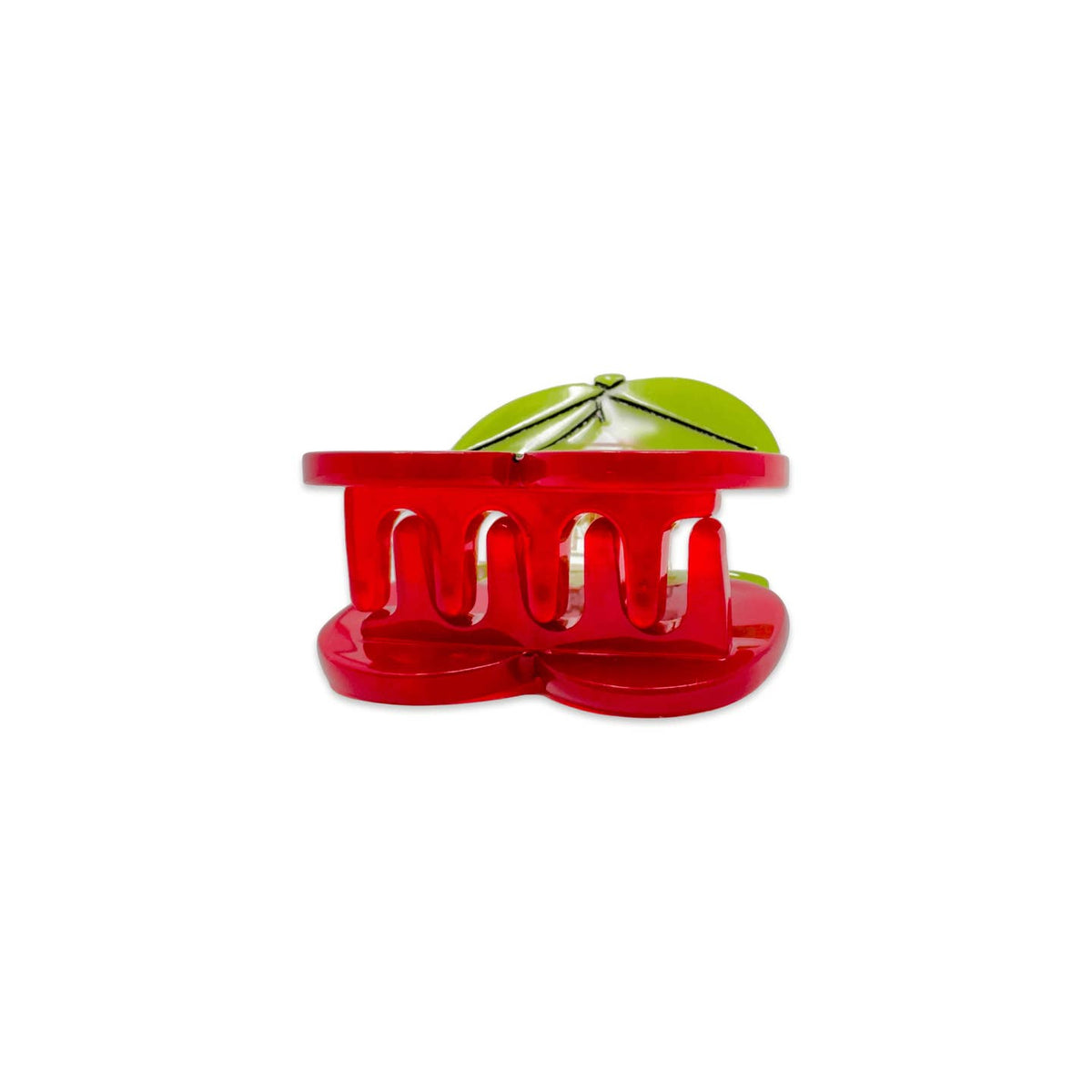 Red plastic tool with a green object inside on a white background