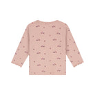A light pink long-sleeve top for toddlers, featuring a delicate all-over print of small vintage cars and stars, with ruffled trim at the cuffs, shown against a plain white background.