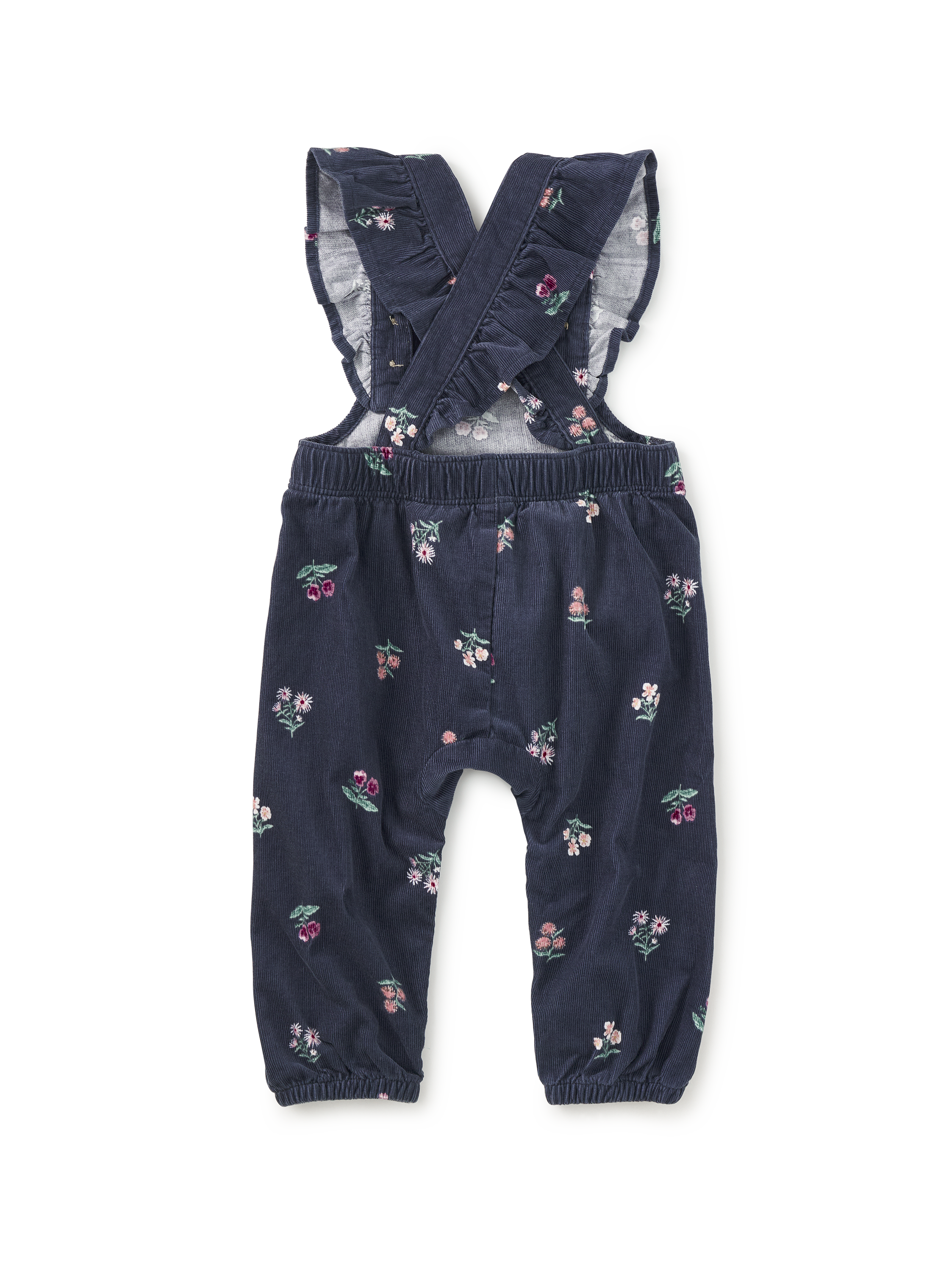 A pair of toddler girl's navy blue corduroy overall with a small pink, green, and white floral print, featuring ruffled shoulder straps and elastic cuffs.