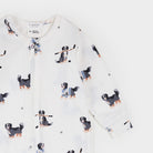 A long-sleeve baby zip-up sleeper by First75, featuring an all-over print of Bernese Mountain Dog puppies wearing hockey gear on a white background.