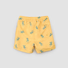 Yellow shorts with green lizard pattern on a light gray background