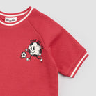 Red sweatshirt with cartoon character and text on a light gray background