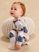 Long sleeve baby romper featuring an all-over vintage steam locomotive train print on a white background.
