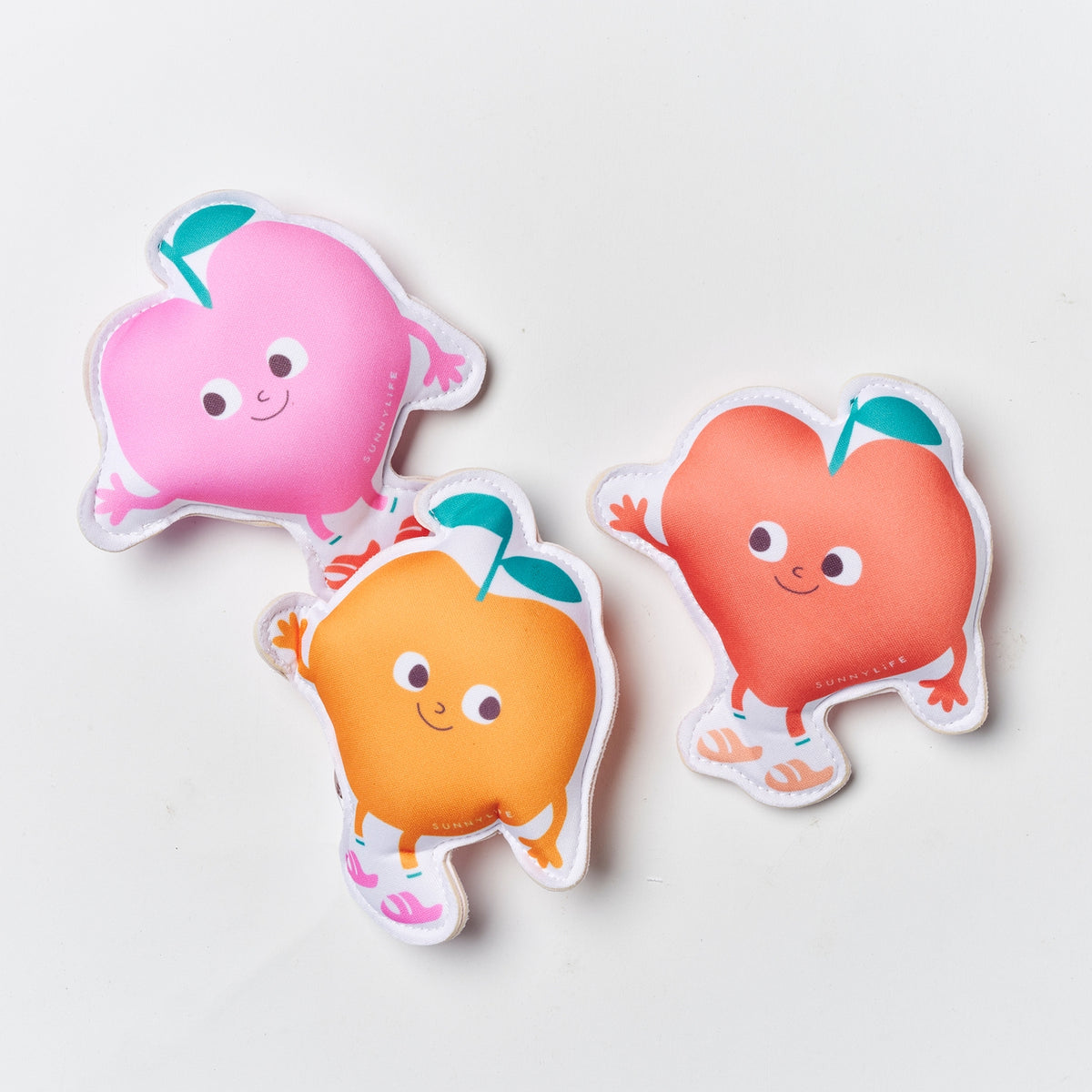 Three colorful character-shaped stickers on a light gray background