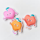 Three colorful character-shaped stickers on a light gray background