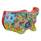 USA-shaped jigsaw puzzle box by Crocodile Creek, featuring a colorful illustrated map of the United States with various cartoon scenes and a blue 'USA PUZZLE' label, on a white background.