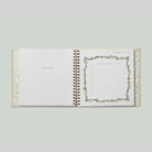 Open book with decorative pages on a light gray background