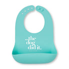 Turquoise bib with 'the dog did it' text on a white background