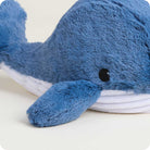 Blue plush whale toy on a light background