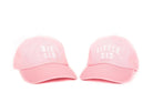 Two pink caps labeled 'BIG SIS' and 'LITTLE SIS' on a white background