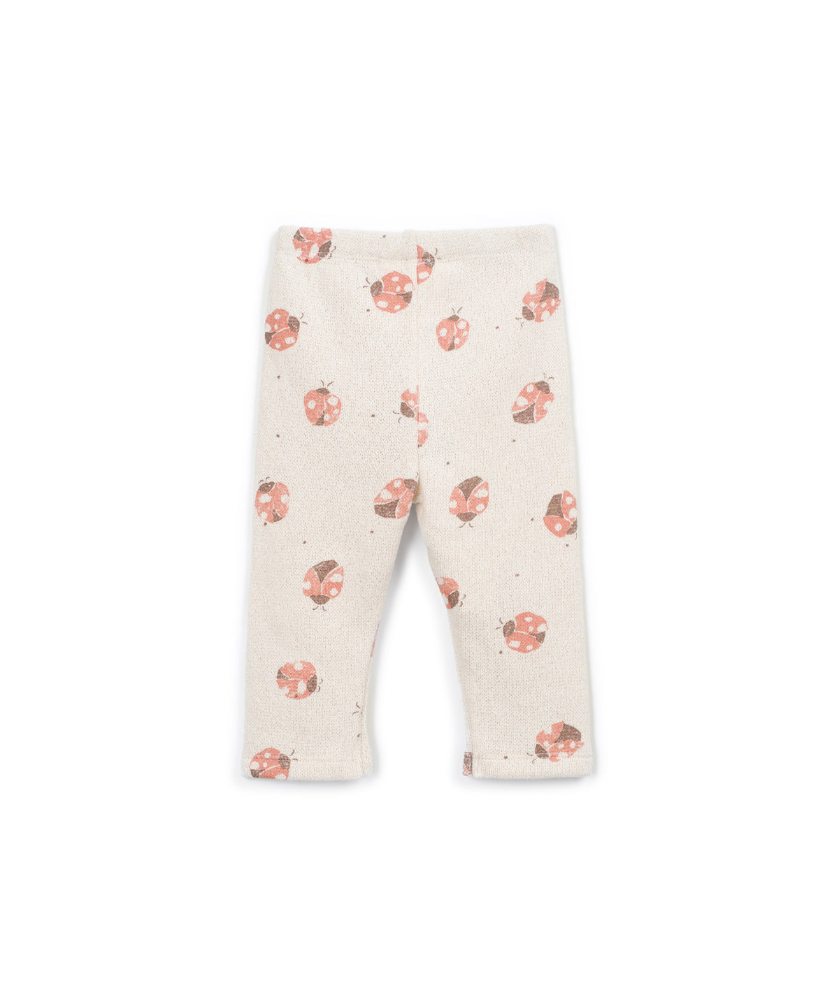 A pair of baby leggings in a warm cream color, featuring a scattered print of pink and orange ladybugs with tiny dark accents.