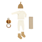 Baby clothing and accessories set including a onesie, hat, socks, and rattle on a white background