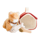 A set including a plush orange and white cat toy, a white fish toy, a brown brush, and a red and beige pet carrier designed for children.