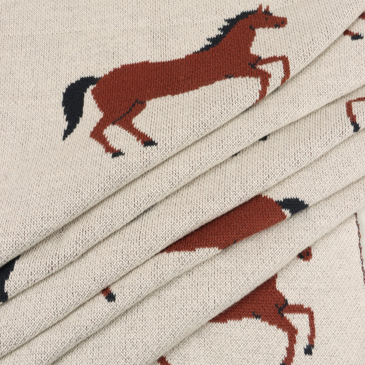 Textile with horse pattern on a beige background