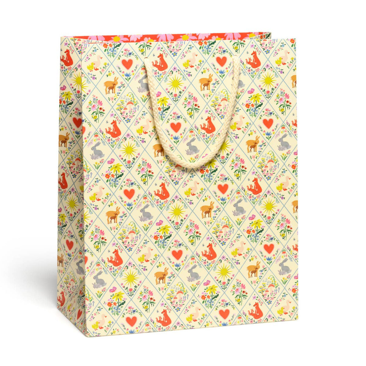 Gift bag with a colorful pattern of animals and flowers on a white background