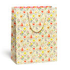 Gift bag with a colorful pattern of animals and flowers on a white background