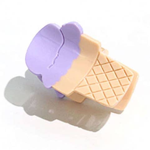 Ice cream cone-shaped cookie cutter with purple top and beige grid pattern on a white background